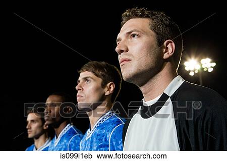 Soccer players standing in line on pitch at night View Large Photo Image Stock Image - Soccer players standing in line on pitch at night. Fotosearch
