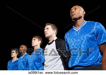 Soccer players standing in line on pitch at night View Large Photo Image Stock Image - Soccer players standing in line on pitch at night. Fotosearch