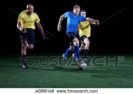 Soccer players tackling on pitch View Large Photo Image Stock Photograph - Soccer players tackling on pitch. Fotosearch