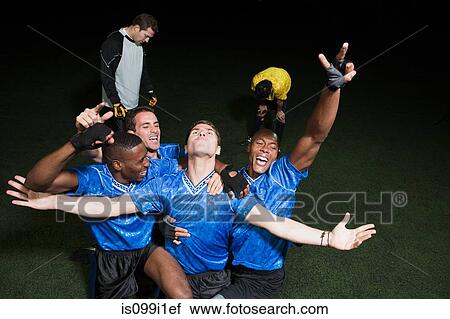 Stock Image - Soccer team celebrating victory. Fotosearch