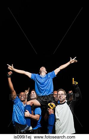 Stock Image - Soccer team celebrating victory. Fotosearch
