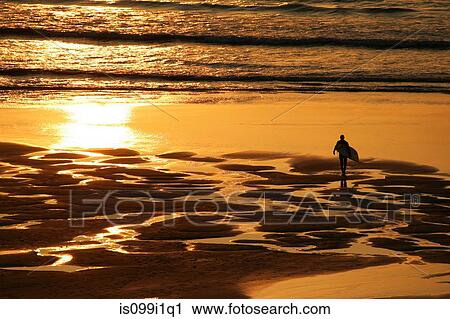 Surfer on beach in Cornwall, UK View Large Photo Image Stock Image - Surfer on beach in Cornwall, UK. Fotosearch