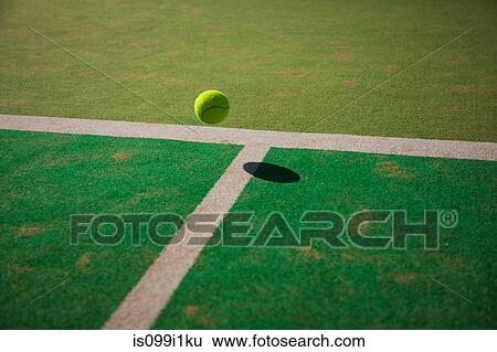 Stock Photograph - Tennis ball bouncing on court. Fotosearch