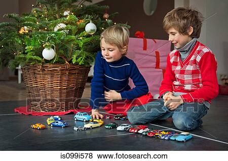 Two boys playing with Christmas presents View Large Photo Image Stock Photo - Two boys playing with Christmas presents. Fotosearch