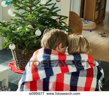 Stock Photo - Two boys wrapped in blanket together. Fotosearch
