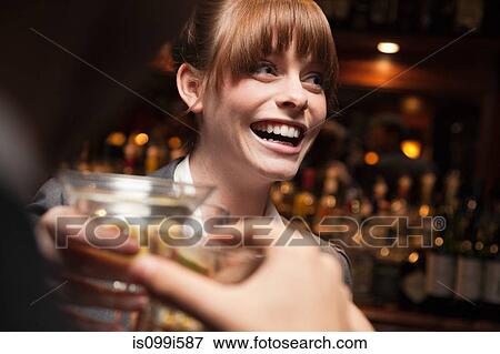 Woman having drinks at bar View Large Photo Image Stock Photo - Woman having drinks at bar. Fotosearch