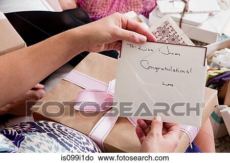 Woman holding up baby shower card View Large Photo Image Picture - Woman holding up baby shower card. Fotosearch