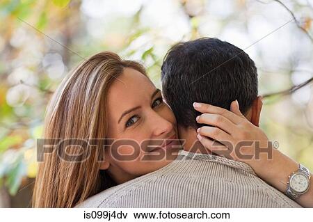 Woman hugging man View Large Photo Image Stock Photo - Woman hugging man. Fotosearch