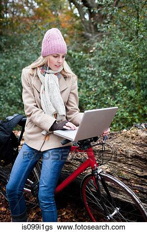 Woman outdoors with laptop and bike View Large Photo Image Stock Photograph - Woman outdoors with laptop and bike. Fotosearch