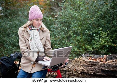 Woman outdoors with laptop and bike View Large Photo Image Stock Photography - Woman outdoors with laptop and bike. Fotosearch