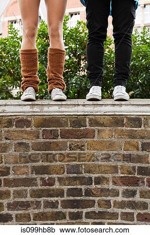 Women in jeans and legwarmers standing on wall View Large Photo Image Stock Image - Women in jeans and legwarmers standing on wall. Fotosearch