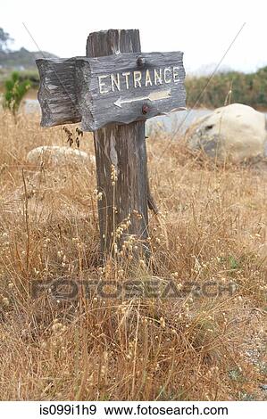 Wooden entrance sign in grass View Large Photo Image Stock Photo - Wooden entrance sign in grass. Fotosearch