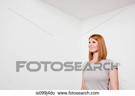 Picture - Young woman in white room. Fotosearch