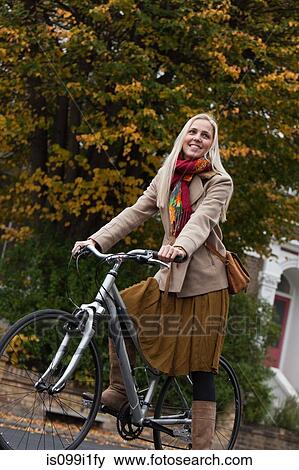 Young woman on bicycle View Large Photo Image Stock Photo - Young woman on bicycle. Fotosearch