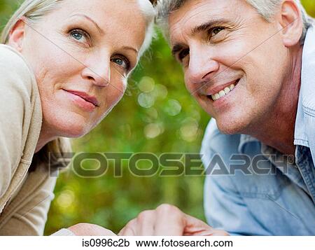 Stock Image - Close up portrait of couple looking away. Fotosearch