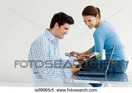 Stock Photography - Couple booking vacation on internet. Fotosearch