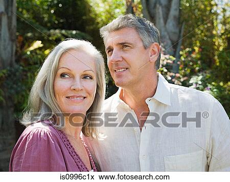 Stock Photo - Couple in garden, portrait. Fotosearch