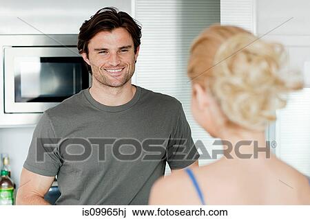 Stock Image - Couple in kitchen. Fotosearch