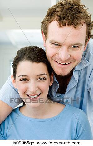 Stock Image - Couple looking at camera, portrait. Fotosearch