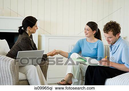 Stock Image - Couple meeting financial advisor at home. Fotosearch