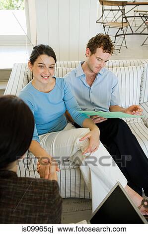 Couple meeting financial advisor at home View Large Photo Image Stock Image - Couple meeting financial advisor at home. Fotosearch