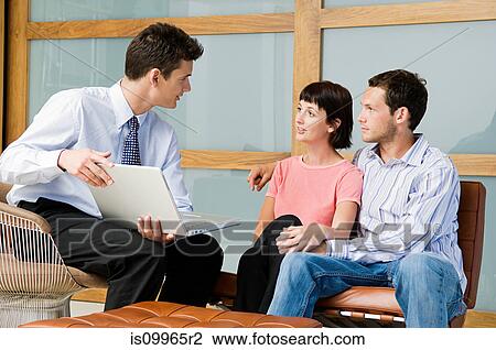 Stock Image - Couple meeting financial advisor. Fotosearch