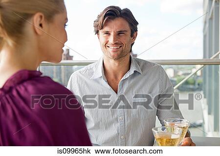 Couple on balcony with wine View Large Photo Image Stock Image - Couple on balcony with wine. Fotosearch
