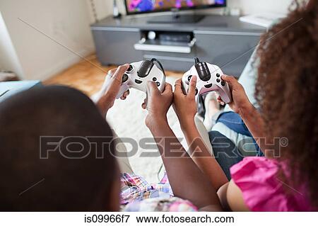 Stock Photo - Couple playing video game at home. Fotosearch