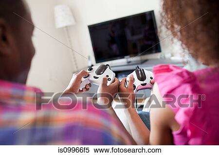Stock Photography - Couple playing video game at home. Fotosearch