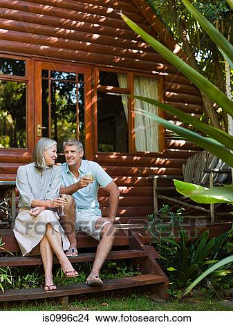 Couple sitting on porch steps in garden View Large Photo Image Picture - Couple sitting on porch steps in garden. Fotosearch
