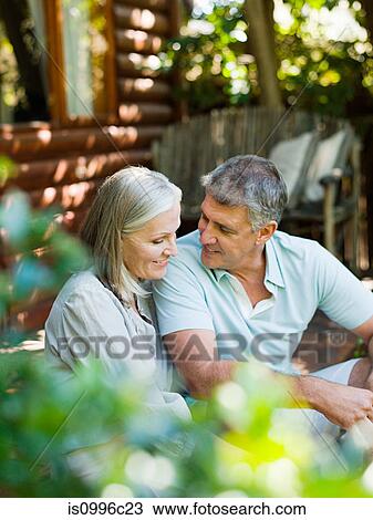 Couple sitting on porch View Large Photo Image Stock Image - Couple sitting on porch. Fotosearch