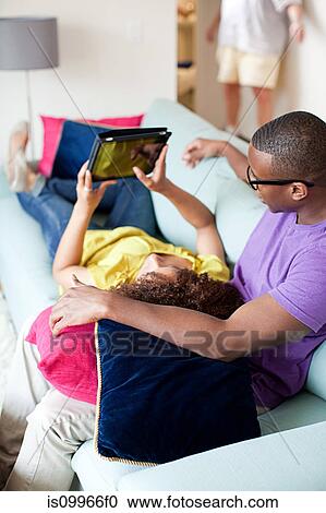Couple using digital tablet at home View Large Photo Image Stock Image - Couple using digital tablet at home. Fotosearch