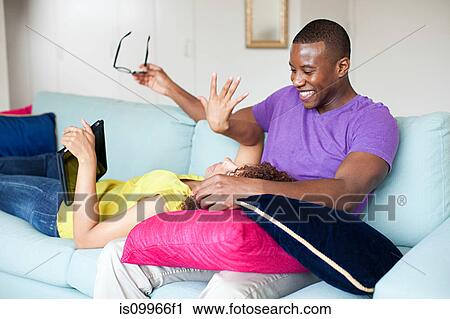 Couple using digital tablet at home View Large Photo Image Stock Image - Couple using digital tablet at home. Fotosearch