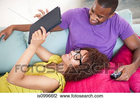Stock Image - Couple using digital tablet at home. Fotosearch