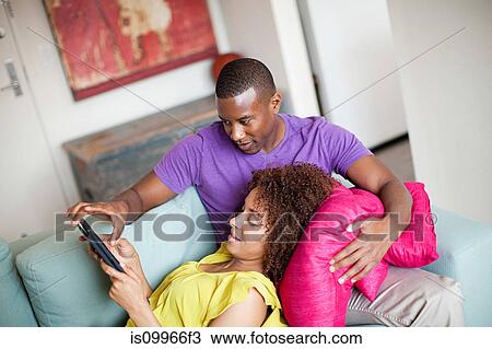 Stock Image - Couple using digital tablet at home. Fotosearch