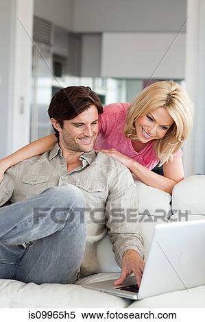 Stock Photography - Couple using laptop at home. Fotosearch