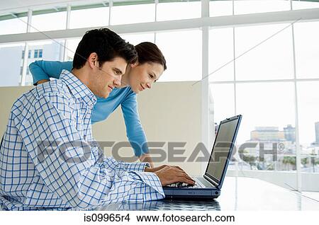 Picture - Couple using laptop. Fotosearch
