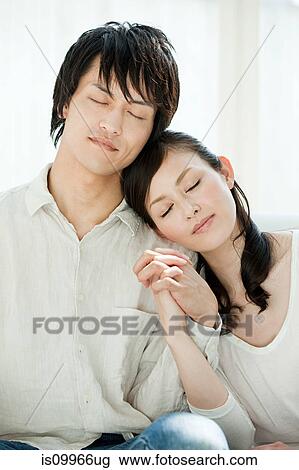 Stock Image - Couple with eyes closed. Fotosearch