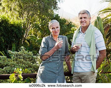 Stock Image - Couple with wine, portrait. Fotosearch