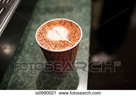 Stock Image - Disposable cup with heart shape in coffee. Fotosearch