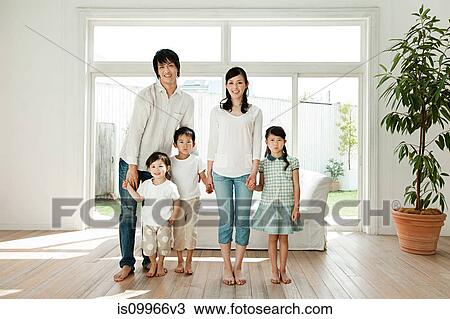 Stock Image - Family with three children at home, portrait. Fotosearch