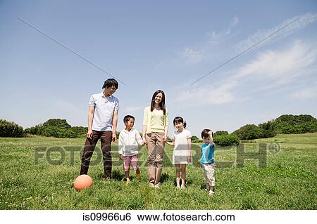 Family with three children in field View Large Photo Image Stock Photograph - Family with three children in field. Fotosearch
