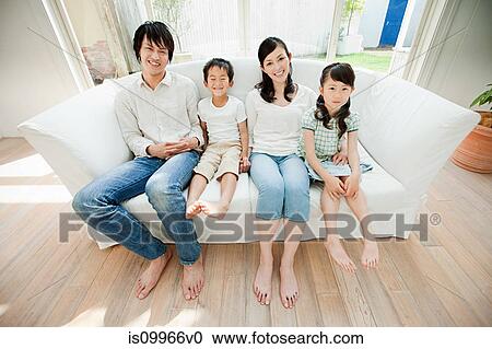 Family with two children on sofa, portrait View Large Photo Image Stock Image - Family with two children on sofa, portrait. Fotosearch