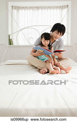 Father reading to daughter View Large Photo Image Stock Photography - Father reading to daughter. Fotosearch