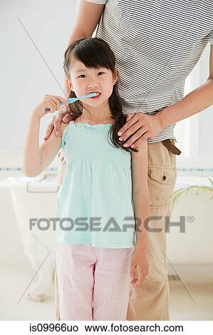 Picture - Girl brushing teeth. Fotosearch