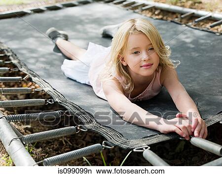 Girl lying on trampoline View Large Photo Image Picture - Girl lying on trampoline. Fotosearch
