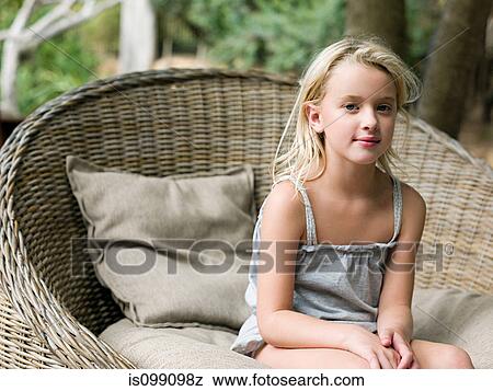 Girl sitting in wicker chair, portrait View Large Photo Image Stock Photo - Girl sitting in wicker chair, portrait. Fotosearch