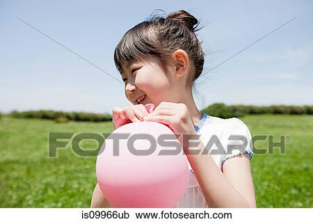 Stock Image - Girl with pink balloon. Fotosearch
