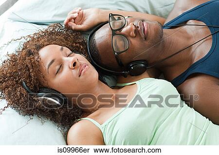 Man and woman listening to music, eyes closed View Large Photo Image Stock Photography - Man and woman listening to music, eyes closed. Fotosearch