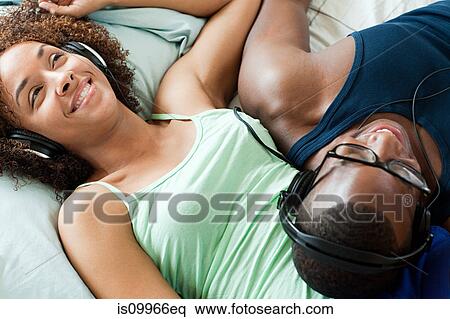 Man and woman listening to music View Large Photo Image Stock Photography - Man and woman listening to music. Fotosearch